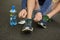 Making sure theyre laced nice and tight. High angle shot of an unrecognizable male runner tying his shoelaces during an