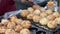 The making of Takoyaki. Takoyaki or Octopus ball is a Japanese food at night market and walking street. Thailand.