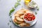 Making tomato basil bruschetta with toasted baguette and herbs