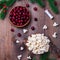 Making traditional handcrafted Christmas popcorn garland with red cranberries, square format