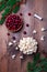 Making traditional handcrafted Christmas popcorn garland with red cranberries, vertical