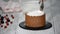 Making trendy rustic vertical roll high cake with chocolate, vanilla cream and raspberries.