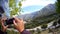 making video on phone pov, mountains on motorcycle pov, sun beams, beautiful landscape, amateur travel video