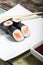 Makisushi on white plate. Seafood maki sushi rolls with chopsticks