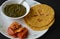 Makki di Roti and Sarson da saag with pickle.Mustard greens cooked until creamy, butter and crispy and soft yellow cornmeal roti.