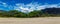 Makua beach panoramic view with beatiful mountains and cloudy sky in the background, Oahu island