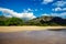 Makua beach view with beatiful mountains and cloudy sky in the background, Oahu island