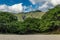 Makua beach view with beatiful mountains and cloudy sky in the background, Oahu island