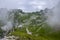 Mala Spice Cime Verdi peaks view from Mangart saddle, Slovenia\\\'s Highest Panoramic Road, heavy clouds before rain, foggy day