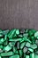 Malachite heap stones texture on half black stone background. Place for text