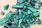 Malachite heap up stones texture on light varnished wood background