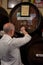 Malaga,Spain 04.04.2019: Bar tender pour the famous pajarete spanish wine from Sherry Barrels in the famous authentic