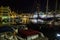 Malaga, Spain - September 03, 2015: Night view of market place with parked boats and building with shops