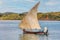 Malagasy fisher on sea in traditional handmade dugout wooden sailing boat