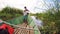 Malagasy man from village on Madagascar river Antainambalana helping ride boat transporting freight