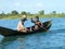 Malagasy natives crossing river by canoe