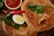 Malawach with hard boiled eggs and tomatoes.  Malawach or malawah: traditional fried bread of Yemenite Jews