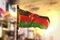 Malawi Flag Against City Blurred Background At Sunrise Backlight