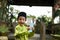 A Malay boy in Malay traditional cloth showing his happy reaction after received money pocket during Eid Fitri or Hari Raya celebr