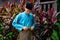 Malay man are wearing traditional cloth and adjusting his samping songket just outside of his traditional wooden house