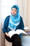 Malay Muslim woman enjoying a relaxing time reading