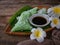 A Malay traditional dessert called Kuih Lopes on bamboo dustpan over wooden background