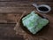 A Malay traditional dessert called Kuih Lopes on right conner over wooden background