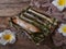 A Malay traditional dessert called Pulut Panggang on plate with flower and cloth decoration over wooden background