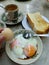 Malaysia breakfast. Half boil egg, toast, coffee, food