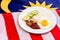 Malaysian Breakfast - Nasi Lemak on Malaysia Flag. It is unofficially the national breakfast dish of Malaysia. Shallow depth of f