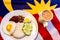 Malaysian Breakfast - Nasi Lemak and Teh Tarik on Malaysia Flag.