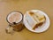 Malaysian breakfast which is milk tea or the tarik, half boiled eggs and kaya butter toast set on the table.