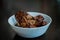 Malaysian dish of Ayam Masak Kicap or deep fried chicken in black soy gravy in a white bowl