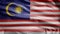 Malaysian flag waving in the wind. Close up of Malaysia banner blowing soft silk