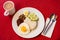 Malaysian Food - Nasi Lemak and Frothy Teh Tarik on a red background. Both dishes are unofficially the national breakfast dish