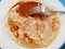 Malaysian fried pancake called Roti Canai with curry gravy and silver fork