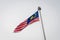 Malaysian national flag on huge flag pole during rain