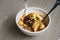 Malaysian noodles laksa soup with chicken, prawn and tofu in a bowl on wooden background