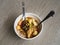 Malaysian noodles laksa soup with chicken, prawn and tofu in a bowl on wooden background