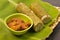 Malaysian traditional food called as LEMANG and chicken rendang. Glutinous rice is wrapped with banan leaf encased in bamboo culm