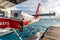 Maldives, Feb 10th 2018 - A seaplane floating in the blue water of Maldives, close to a wood deck with some clouds in the sky.