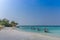 Maldives, Feb 3rd 2018 - Beach umbrellas at the shallow blue water with some divers enjoying the tropical weather of Maldives