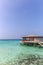 Maldives, Feb 8th 2018 - A part of the Cestara hotel over the blue water beach, calm waters in the lagoon in a clear sky in Maldiv