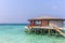 Maldives, Feb 8th 2018 - A part of the Cestara hotel over the blue water beach, calm waters in the lagoon in a clear sky in Maldiv