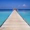 Maldives Island Resort Wood Pier and Turquoise Pacific Ocean Water.