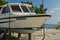 Maldives - November, 2017: Amazing beach on Maldives with old picturesque wooden boat on the white sand and local people bathing