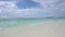 Maldives. Ocean wave on tropical beach. White sand and crystal-blue ocean.
