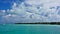 Maldives. Paradise vacation. A boat rushes across the calm aquamarine ocean.