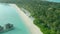 Maldives tropical beach with coconut palm trees and resort area and white sand beach. Drone view