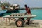 MALDIVES â€“ November, 2017: Worker carrying gas cylinder on a pier, tropical Gulhi Island in Indian Ocean, Maldives